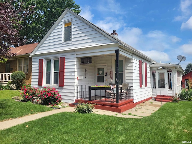 1603 Oak St, Quincy, IL 62301 - view of front of home with covered porch, a front lawn, and a chimney