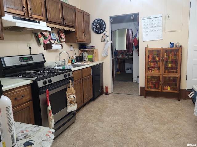 1603 Oak St, Quincy, IL 62301 - kitchen with stainless steel gas range, under cabinet range hood, black dishwasher, and light countertops