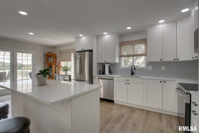1521 Silverthorne Dr, Quincy, IL 62305 - kitchen featuring stainless steel appliances, tasteful backsplash, white cabinets, light wood-style floors, and recessed lighting