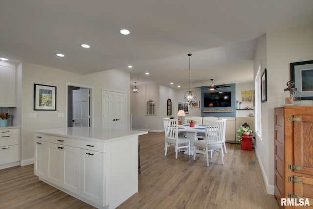 1521 Silverthorne Dr, Quincy, IL 62305 - kitchen featuring recessed lighting, light wood finished floors, white cabinetry, and open floor plan