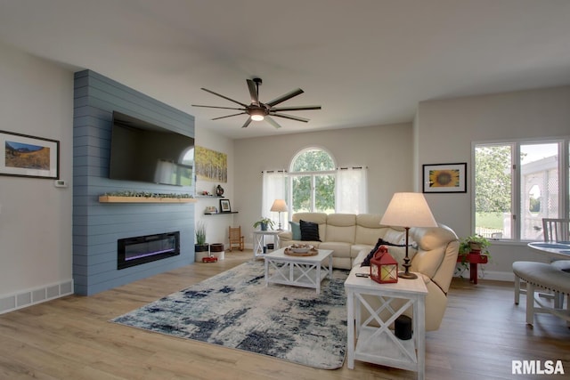 1521 Silverthorne Dr, Quincy, IL 62305 - living room featuring ceiling fan, wood finished floors, and a large fireplace