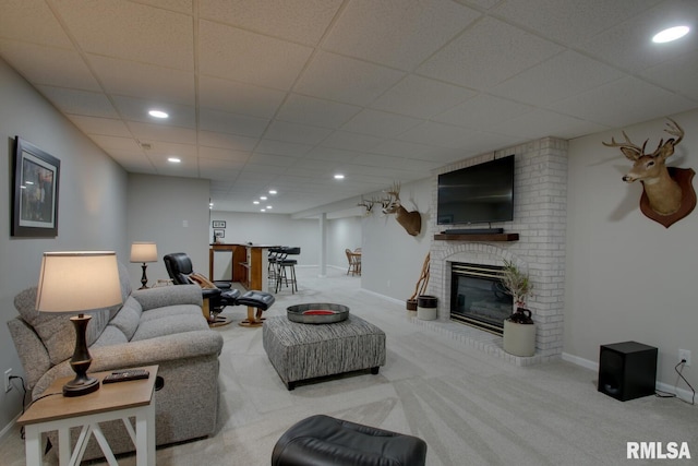 1521 Silverthorne Dr, Quincy, IL 62305 - carpeted living area featuring a drop ceiling, a brick fireplace, and recessed lighting