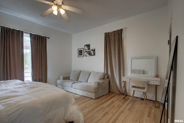2117 Hampshire St, Quincy, IL 62301 - bedroom with light wood finished floors, a textured ceiling, and a ceiling fan
