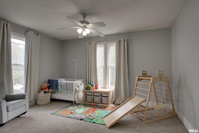 2117 Hampshire St, Quincy, IL 62301 - carpeted bedroom featuring multiple windows, a ceiling fan, and a textured ceiling