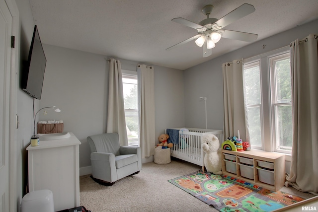 2117 Hampshire St, Quincy, IL 62301 - carpeted bedroom featuring a crib and a ceiling fan
