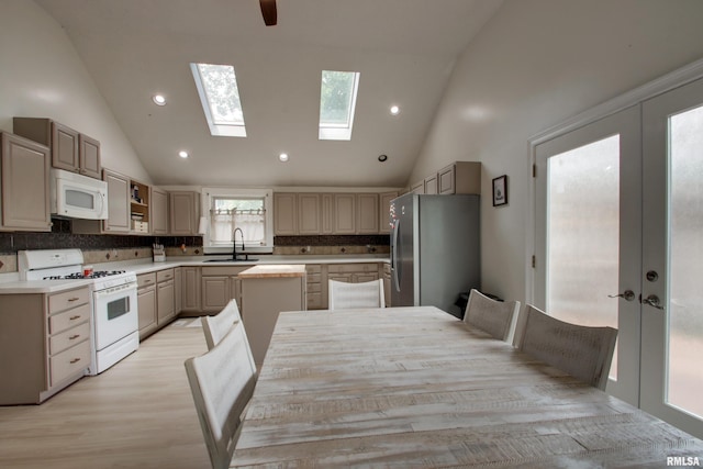 2117 Hampshire St, Quincy, IL 62301 - kitchen featuring white appliances, decorative backsplash, high vaulted ceiling, light countertops, and french doors