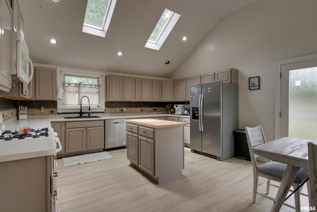 2117 Hampshire St, Quincy, IL 62301 - kitchen with stainless steel appliances, tasteful backsplash, a kitchen island, a skylight, and recessed lighting