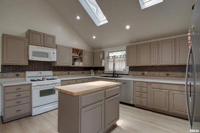 2117 Hampshire St, Quincy, IL 62301 - kitchen with stainless steel appliances, wood counters, a skylight, a center island, and light wood-style flooring