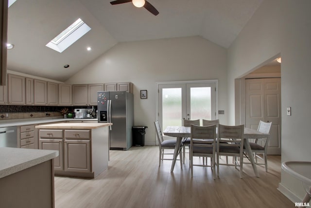 2117 Hampshire St, Quincy, IL 62301 - kitchen with appliances with stainless steel finishes, ceiling fan, a skylight, tasteful backsplash, and light wood-style flooring
