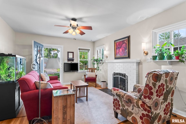 1935 S Douglas Ave, Springfield, IL 62704 - living room with a ceiling fan, a brick fireplace, and wood finished floors