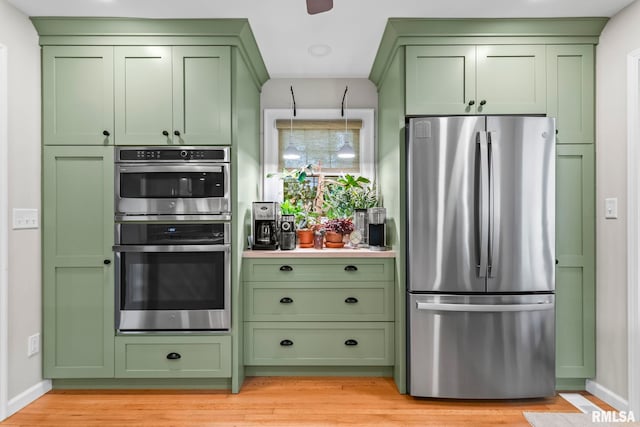 1935 S Douglas Ave, Springfield, IL 62704 - kitchen with green cabinets, appliances with stainless steel finishes, light wood-style flooring, and light countertops