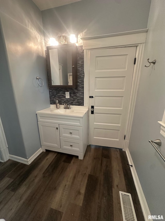 1249 W Urban Ave, Springfield, IL 32704 - bathroom featuring vanity, wood finished floors, and backsplash
