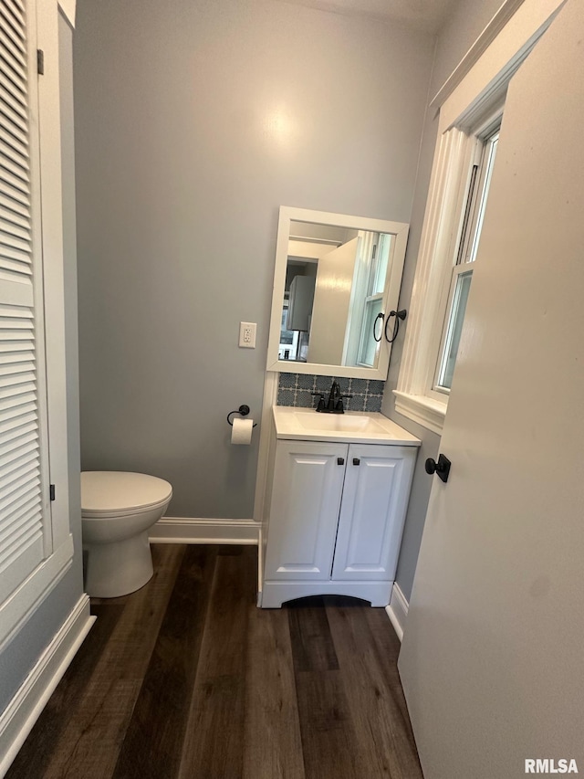 1249 W Urban Ave, Springfield, IL 32704 - half bathroom featuring wood finished floors, vanity, and decorative backsplash