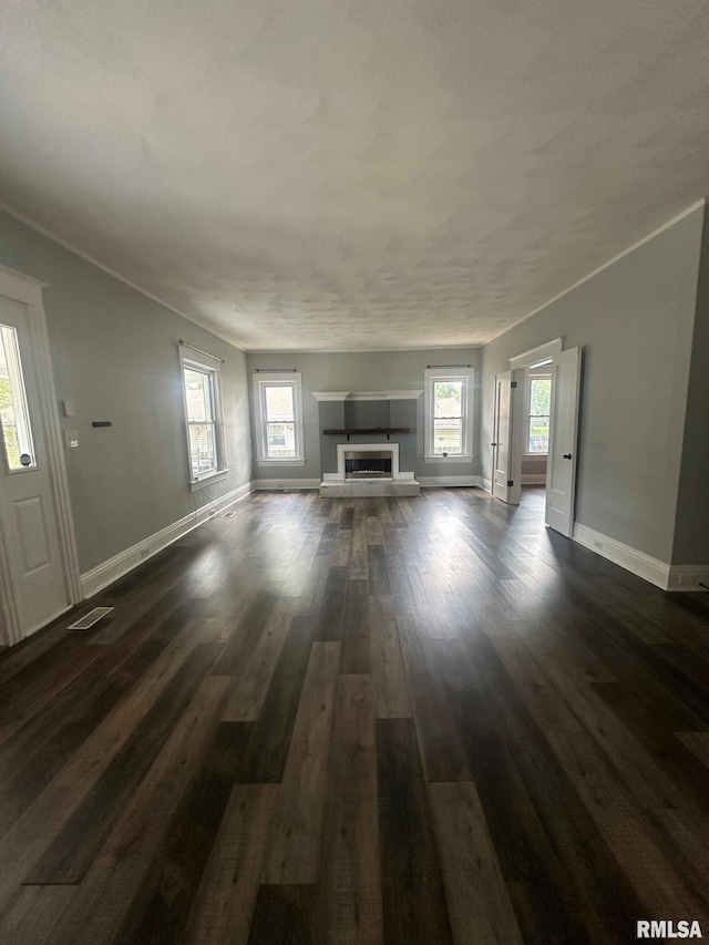 1249 W Urban Ave, Springfield, IL 32704 - unfurnished living room with dark wood-style flooring and a tiled fireplace