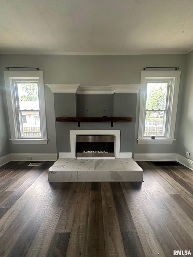 1249 W Urban Ave, Springfield, IL 32704 - unfurnished living room with healthy amount of natural light, wood finished floors, and a fireplace with raised hearth