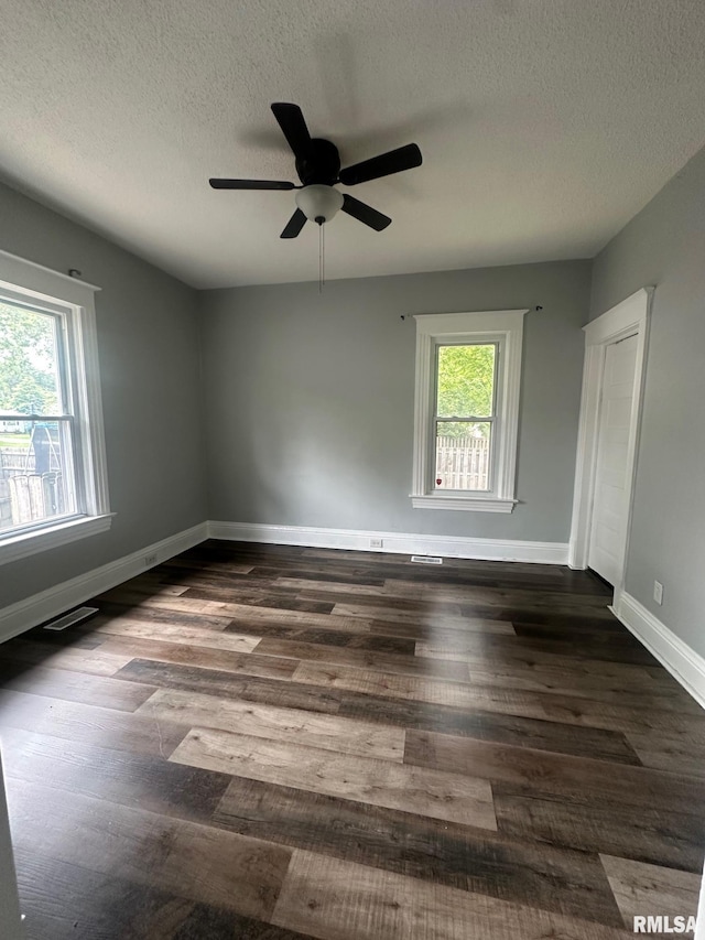 1249 W Urban Ave, Springfield, IL 32704 - spare room with healthy amount of natural light, ceiling fan, dark wood-style flooring, and a textured ceiling