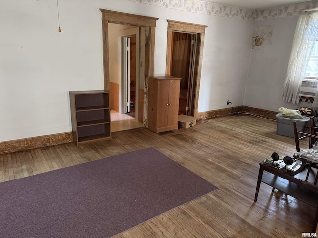 222 N Broadway St, Havana, IL 62644 - unfurnished living room featuring wood finished floors and baseboards