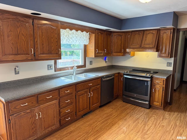 1804 Hunter Ridge Dr, Springfield, IL 62704 - kitchen featuring stainless steel appliances, light wood finished floors, dark countertops, brown cabinets, and custom exhaust hood