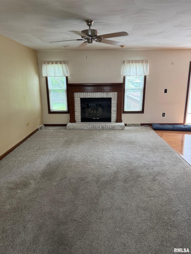 1804 Hunter Ridge Dr, Springfield, IL 62704 - unfurnished living room with a ceiling fan, a brick fireplace, and carpet