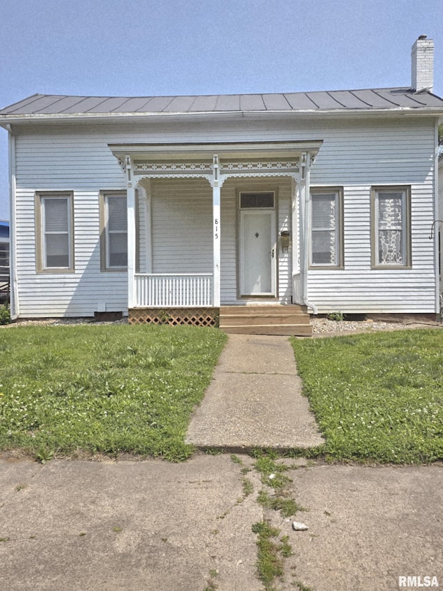 815 Washington St, Quincy, IL 62301 - view of front of house with a porch, a standing seam roof, a chimney, and a metal roof
