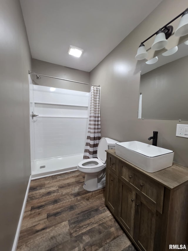 815 Washington St, Quincy, IL 62301 - bathroom featuring wood finished floors, curtained shower, and vanity