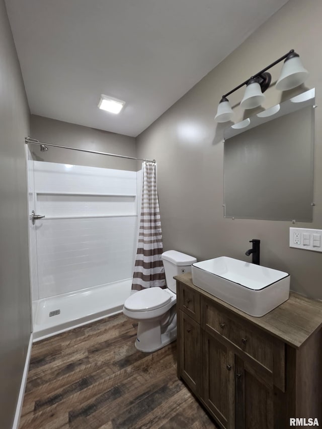 815 Washington St, Quincy, IL 62301 - bathroom featuring wood finished floors, vanity, and a shower with shower curtain