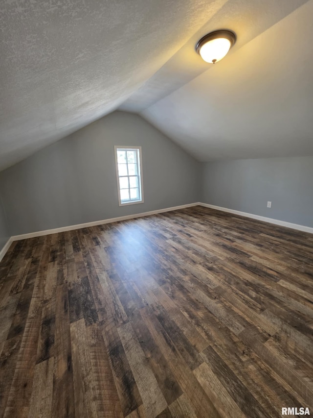 815 Washington St, Quincy, IL 62301 - bonus room with dark wood-style floors, vaulted ceiling, and a textured ceiling