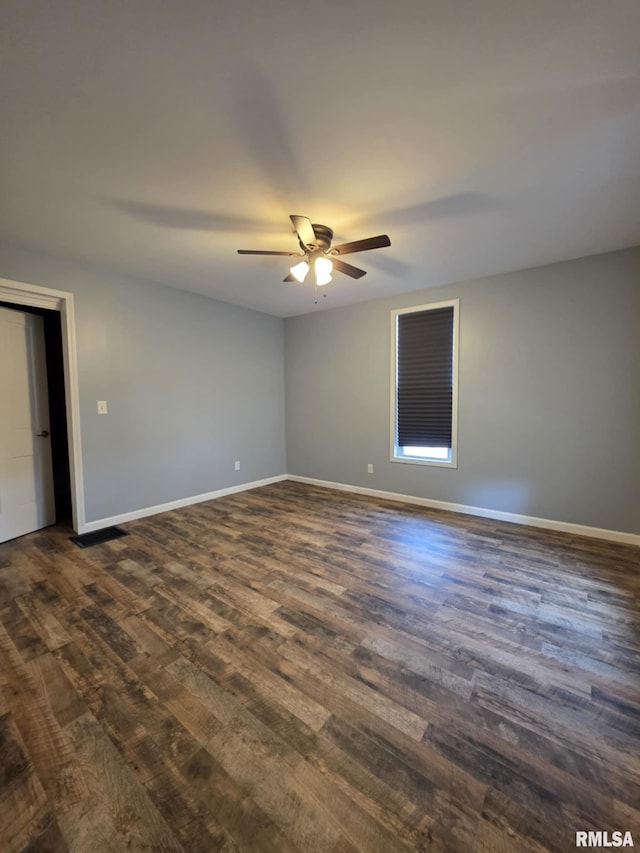 815 Washington St, Quincy, IL 62301 - spare room featuring dark wood-style flooring and a ceiling fan