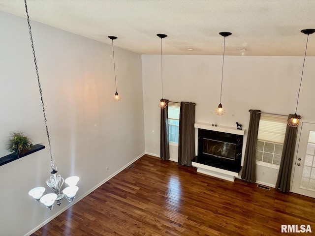 3205 Ashley Ln, Springfield, IL 62711 - unfurnished living room featuring wood finished floors, a glass covered fireplace, healthy amount of natural light, and a towering ceiling