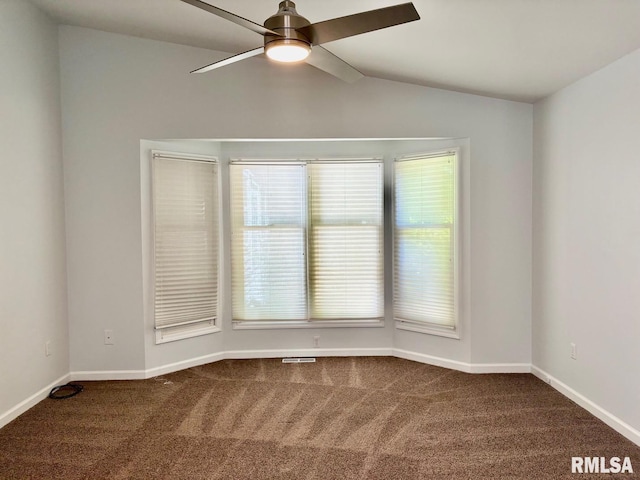 3205 Ashley Ln, Springfield, IL 62711 - empty room featuring dark colored carpet, ceiling fan, vaulted ceiling, and plenty of natural light