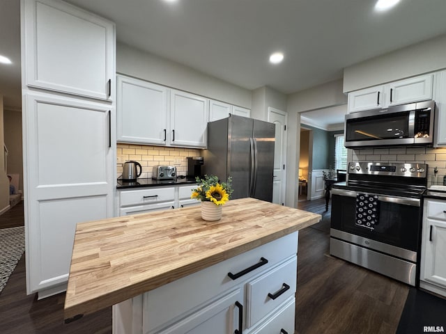125 Pinehurst Dr, Springfield, IL 62704 - kitchen featuring appliances with stainless steel finishes, wood counters, dark wood-style flooring, recessed lighting, and white cabinetry