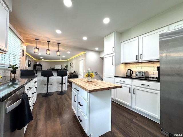 125 Pinehurst Dr, Springfield, IL 62704 - kitchen featuring appliances with stainless steel finishes, wooden counters, recessed lighting, dark wood-type flooring, and decorative backsplash