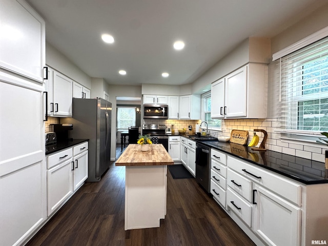 125 Pinehurst Dr, Springfield, IL 62704 - kitchen with butcher block countertops, stainless steel appliances, backsplash, white cabinetry, and dark wood-style flooring