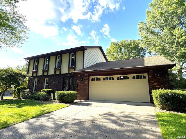 125 Pinehurst Dr, Springfield, IL 62704 - view of front of house with brick siding, an attached garage, concrete driveway, and a front lawn