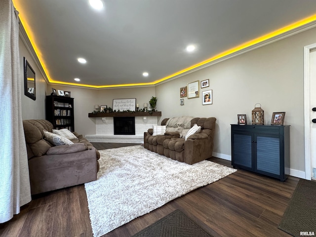 125 Pinehurst Dr, Springfield, IL 62704 - living room with dark wood-type flooring, recessed lighting, and a brick fireplace