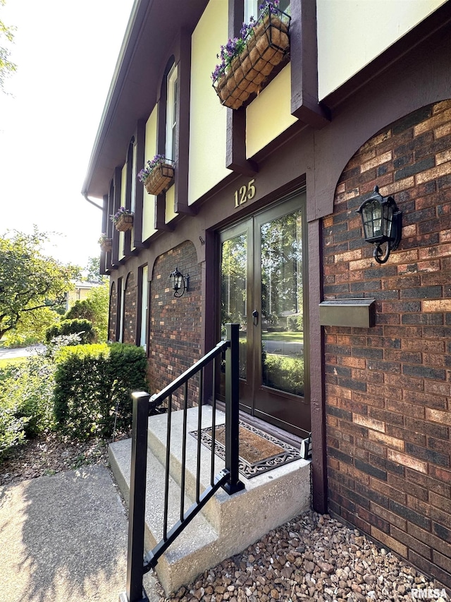 125 Pinehurst Dr, Springfield, IL 62704 - doorway to property with brick siding, french doors, and stucco siding