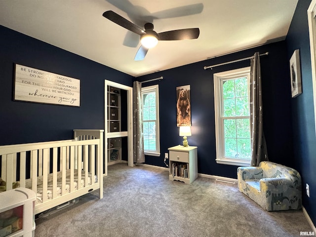 125 Pinehurst Dr, Springfield, IL 62704 - carpeted bedroom with multiple windows, a nursery area, and a ceiling fan
