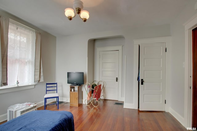 229 S 11th St, Quincy, IL 62301 - bedroom with wood finished floors, a chandelier, and multiple windows