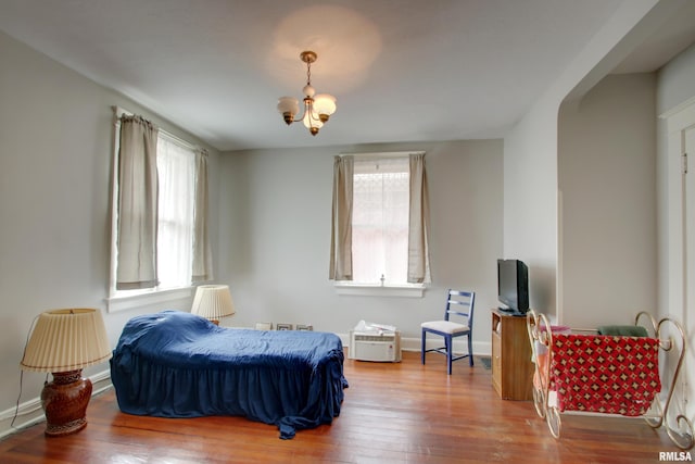 229 S 11th St, Quincy, IL 62301 - bedroom with multiple windows, a chandelier, and wood finished floors