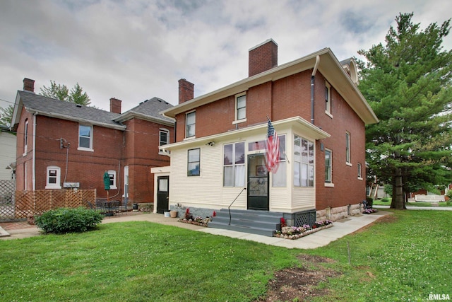 229 S 11th St, Quincy, IL 62301 - back of house with entry steps, a chimney, a yard, and brick siding