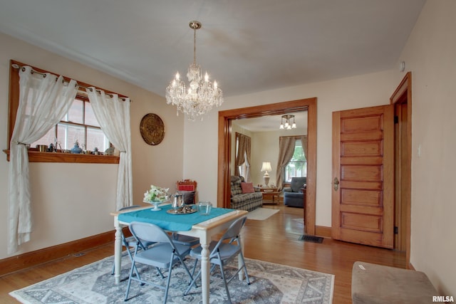 229 S 11th St, Quincy, IL 62301 - dining room with a chandelier and wood finished floors