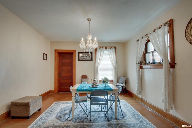 229 S 11th St, Quincy, IL 62301 - dining room featuring a chandelier and light wood finished floors
