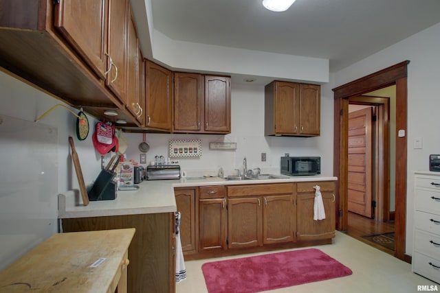 229 S 11th St, Quincy, IL 62301 - kitchen with black microwave, light countertops, and brown cabinets