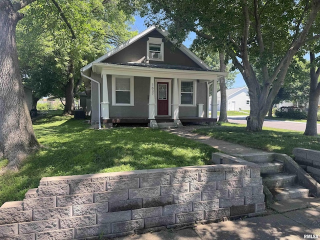 1637 Spruce St, Quincy, IL 62301 - view of front of property with a front lawn, covered porch, stucco siding, and cooling unit