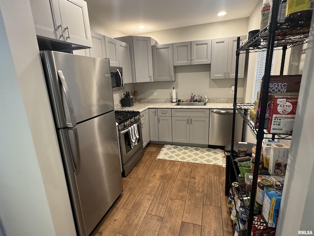 1637 Spruce St, Quincy, IL 62301 - kitchen featuring stainless steel appliances, dark wood-style floors, gray cabinetry, recessed lighting, and light stone countertops