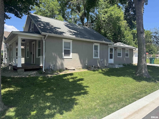 1637 Spruce St, Quincy, IL 62301 - view of front of house with a front lawn, stucco siding, covered porch, and a shingled roof