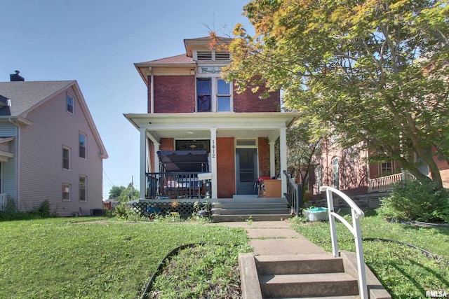 1412 Oak St, Quincy, IL 62301 - american foursquare style home featuring brick siding, covered porch, and a front lawn