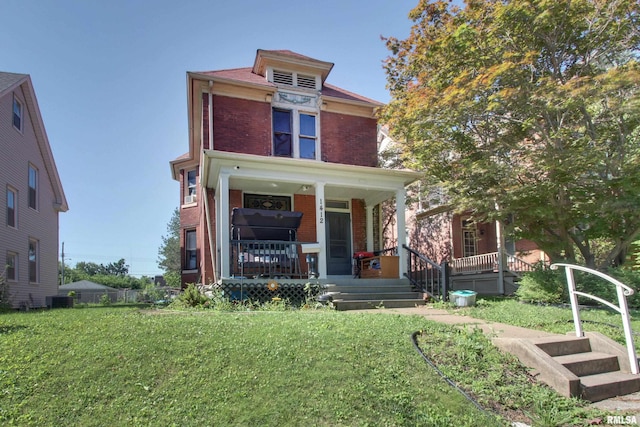 1412 Oak St, Quincy, IL 62301 - traditional style home featuring brick siding, a porch, and a front lawn