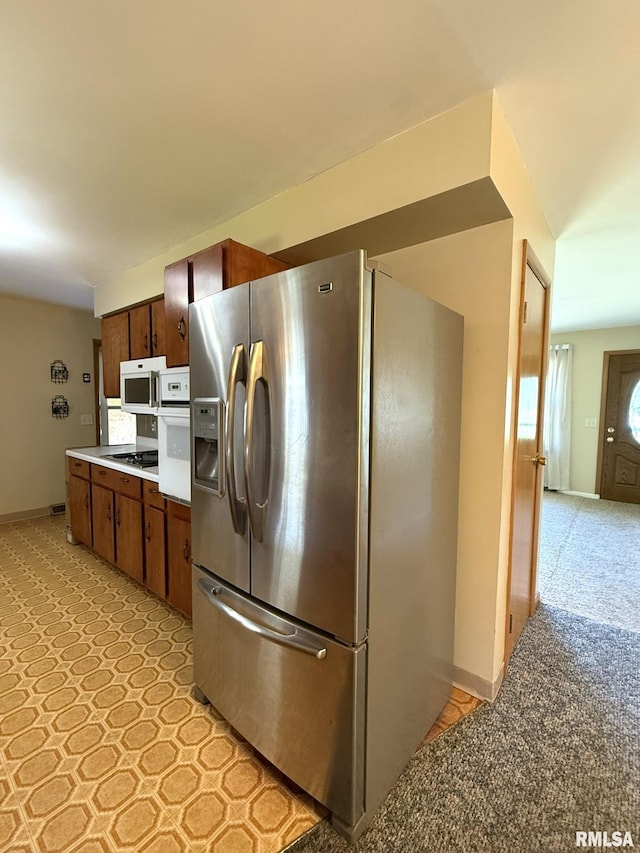 903 N Fearing Ave, Abingdon, IL 61410 - kitchen with white appliances, light countertops, and brown cabinetry