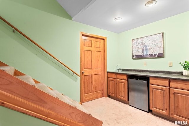 1860 Mayfield Rd, Chatham, IL 62629 - kitchen featuring fridge, light colored carpet, dark countertops, brown cabinetry, and lofted ceiling